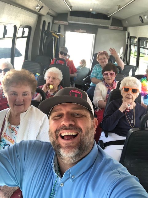 group smiling on bus